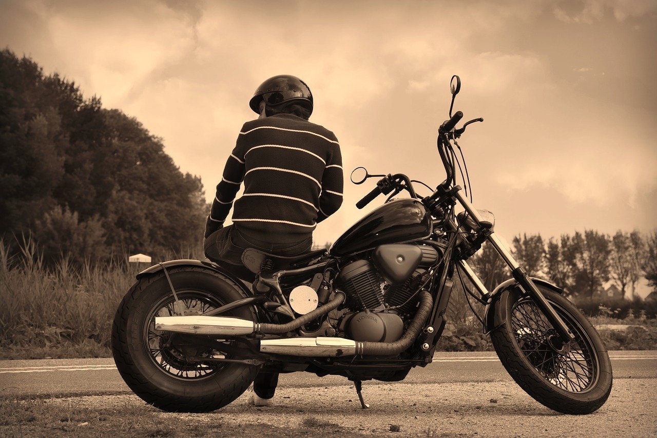 Motorcyclist waiting for the breakdown truck to arrive
